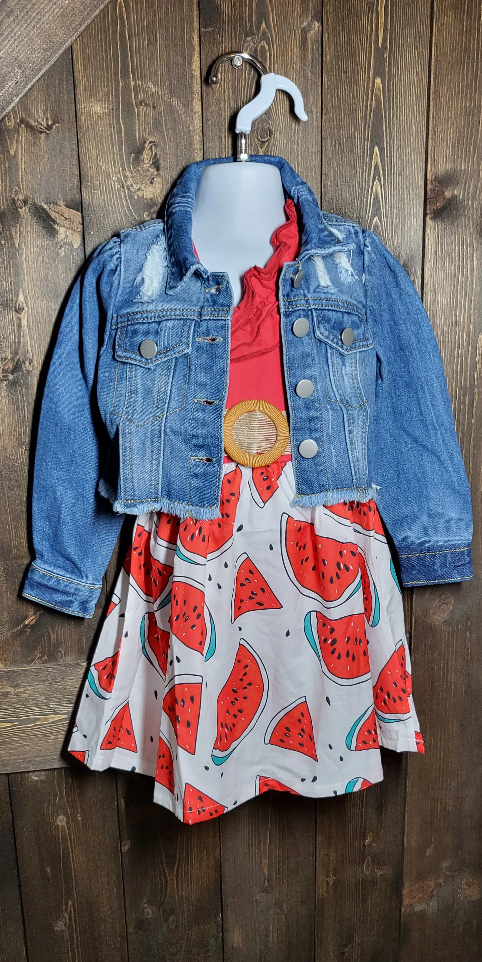 Adorable girls dresses in cowprint, sunflower, and watermelon with a cropped jean jacket