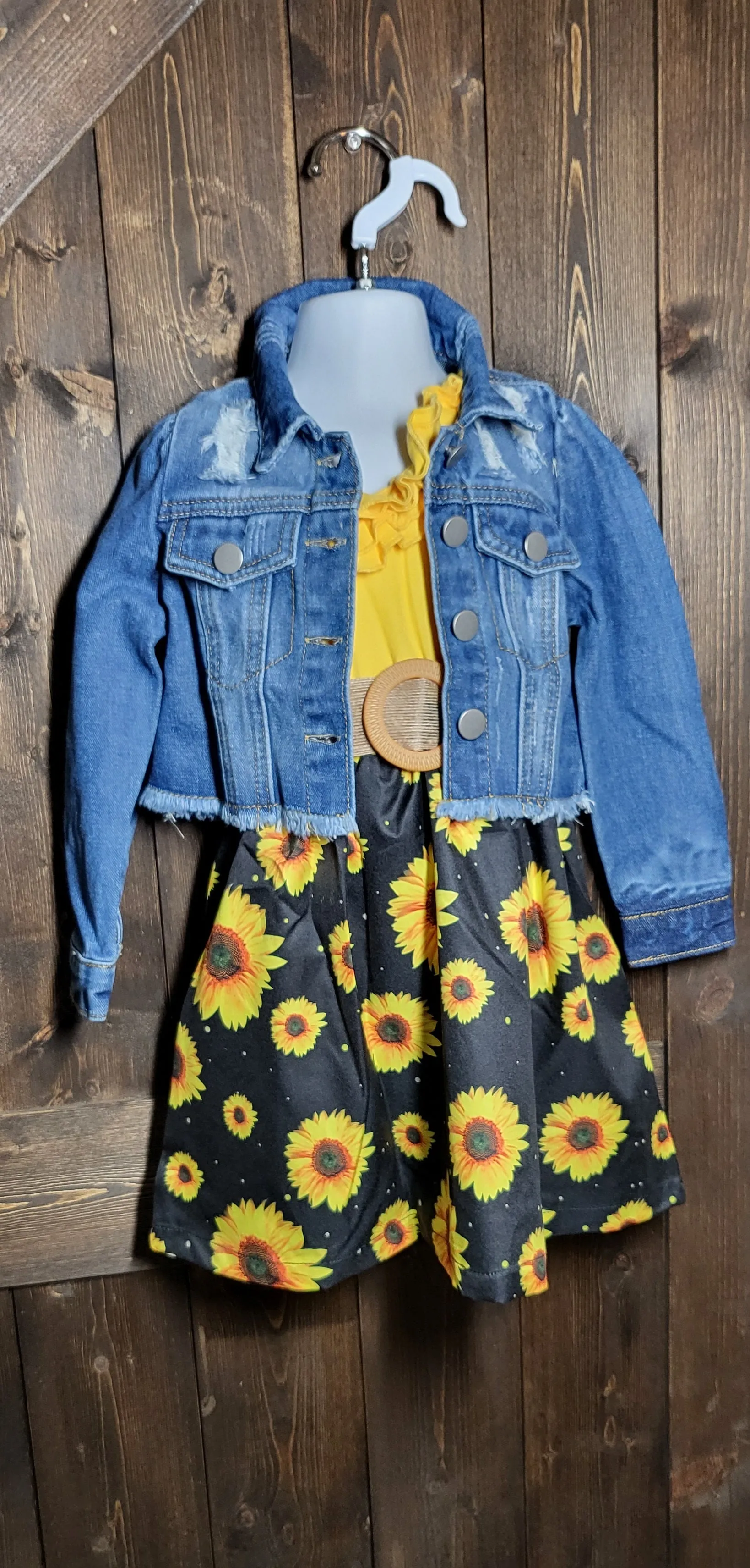 Adorable girls dresses in cowprint, sunflower, and watermelon with a cropped jean jacket