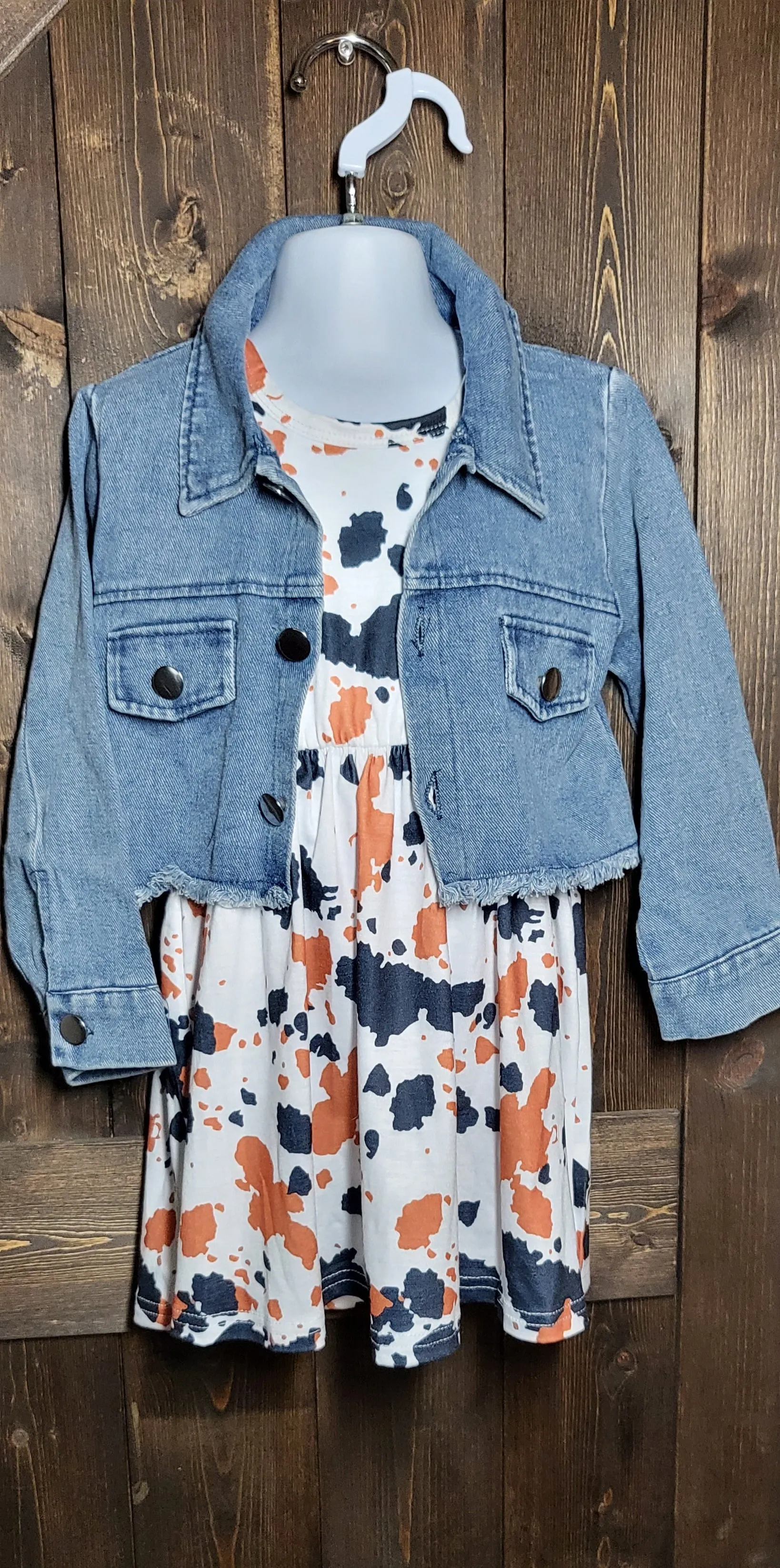 Adorable girls dresses in cowprint, sunflower, and watermelon with a cropped jean jacket